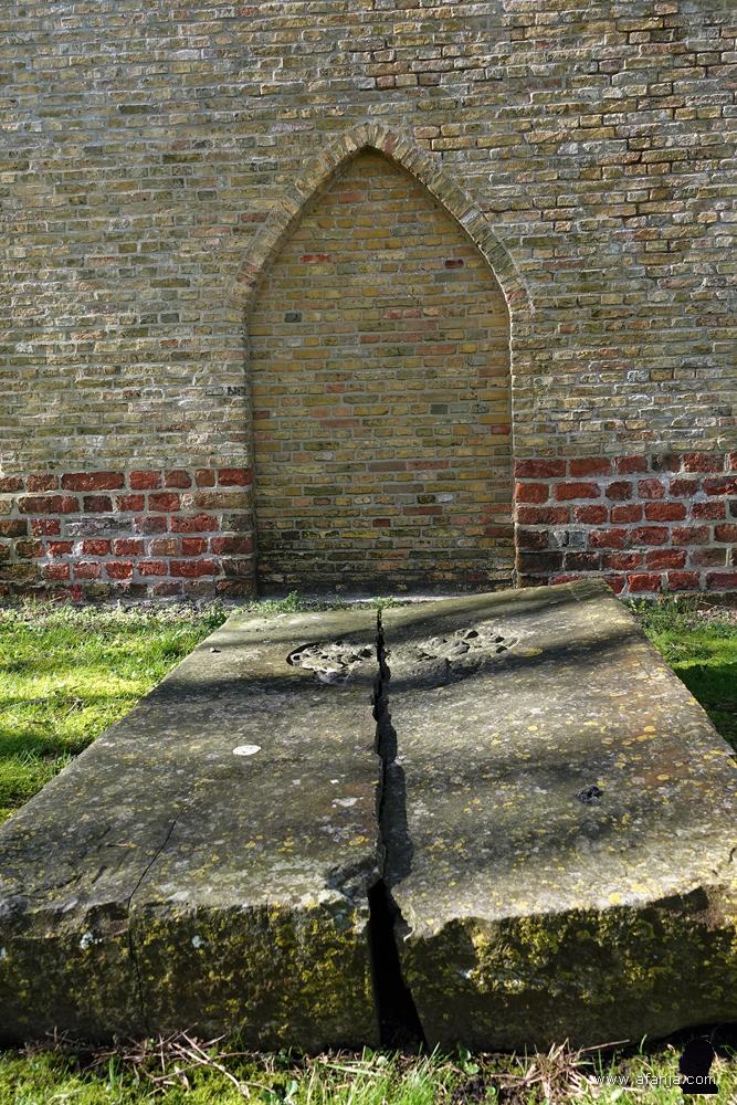 oude grafstenen achter de toren dekken de grafkelder van boer Johan Jellema